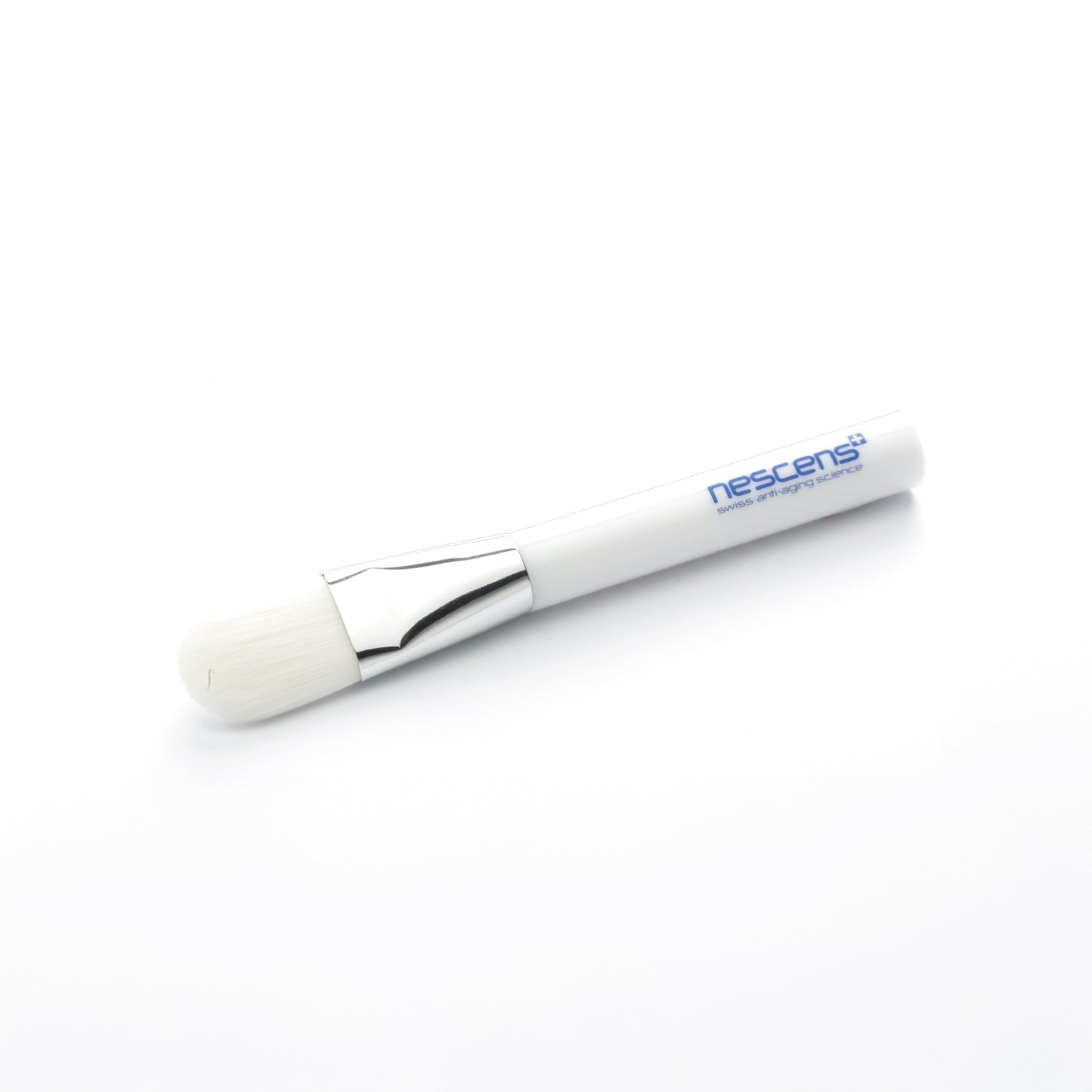 Skincare application brush with Nescens logo